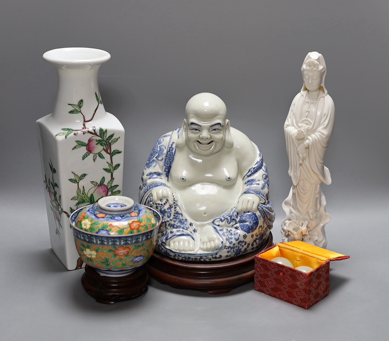 A Chinese peach vase, Buddha, two hardstone balls and a blanc de chine figure and a bowl and cover on stand, peach vase 32 cms high